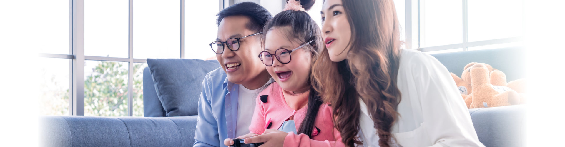 parents playing video games with their child with down syndrome